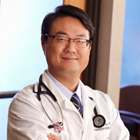 Sunny Kim MD Decompression Mastermind Certification Dr. Sunny Kim smiling headshot in lab coat